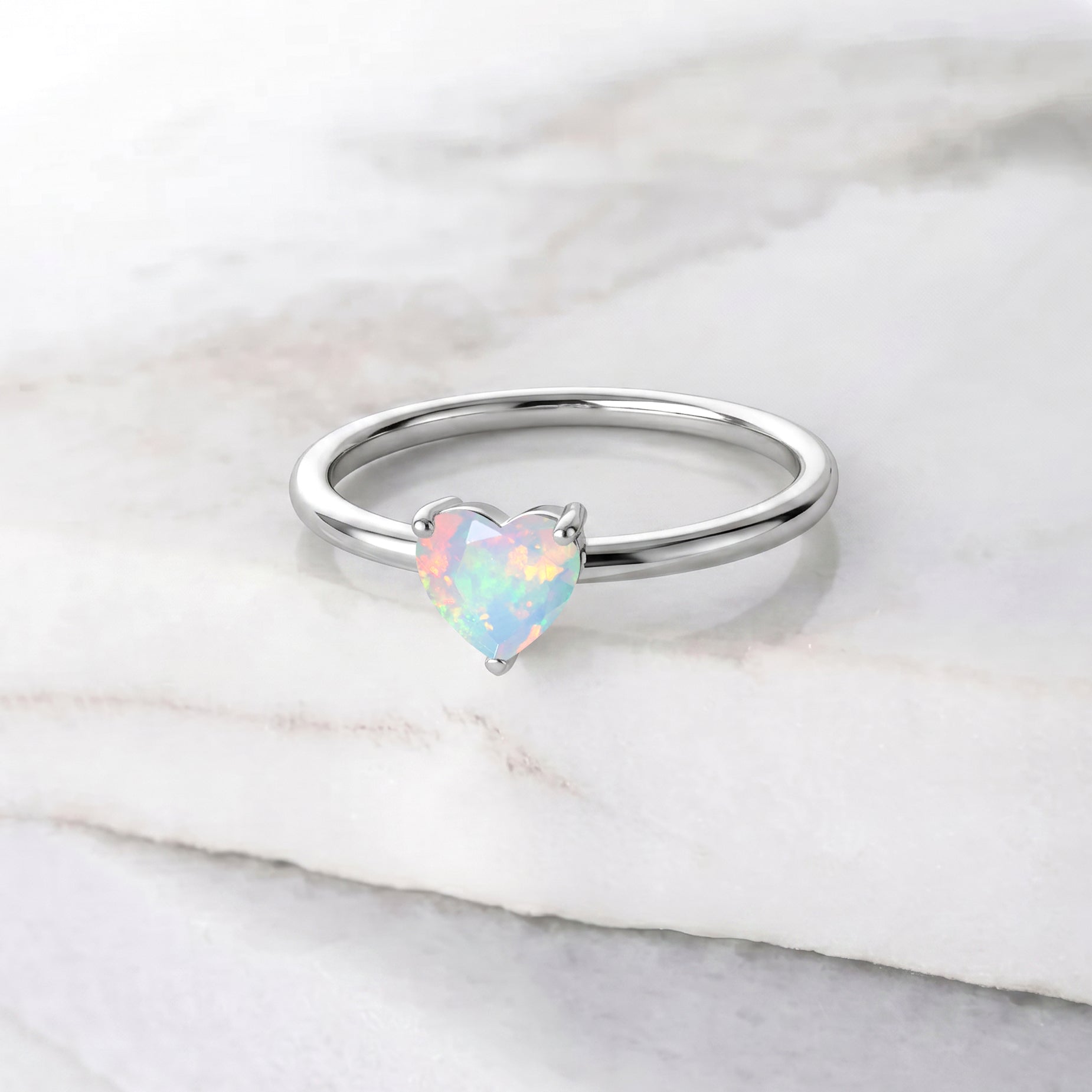 heart gemstone jewelry, natural white opal stone, october jewelry gift, solitaire ring setting, elegant women's jewelry, handcrafted gemstone accessory, delicate everyday ring, anniversary jewelry, birthday gift idea, bridal jewelry, classic heart ring, fine jewelry design, polished craftsmanship, modern elegance, feminine accessory