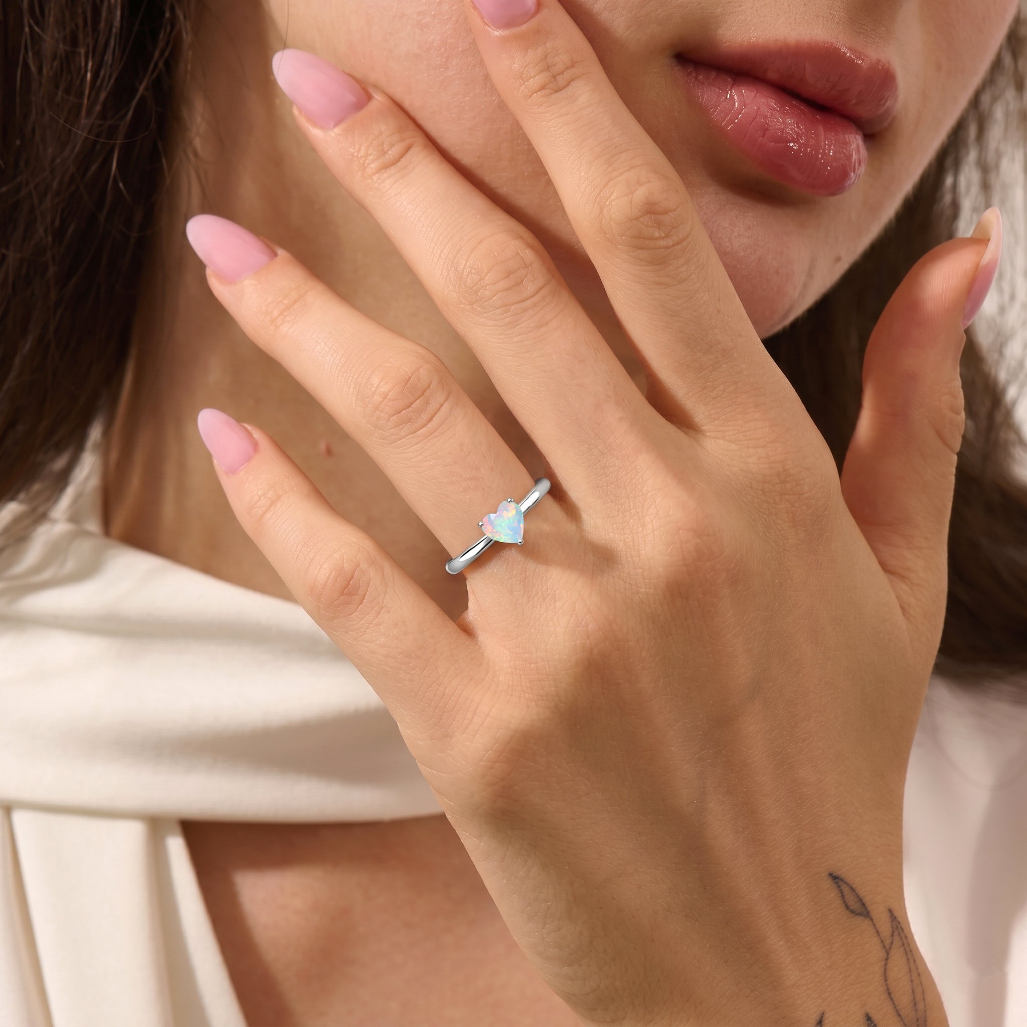 natural gemstone solitaire jewelry, white opal heart ring, october birthstone design, elegant handcrafted ring, fine women's jewelry, polished finish, three prong gemstone setting, stackable accessory, dainty gemstone jewelry, bridal gift, anniversary jewelry, birthday keepsake, romantic jewelry, artisan craftsmanship, classic elegance