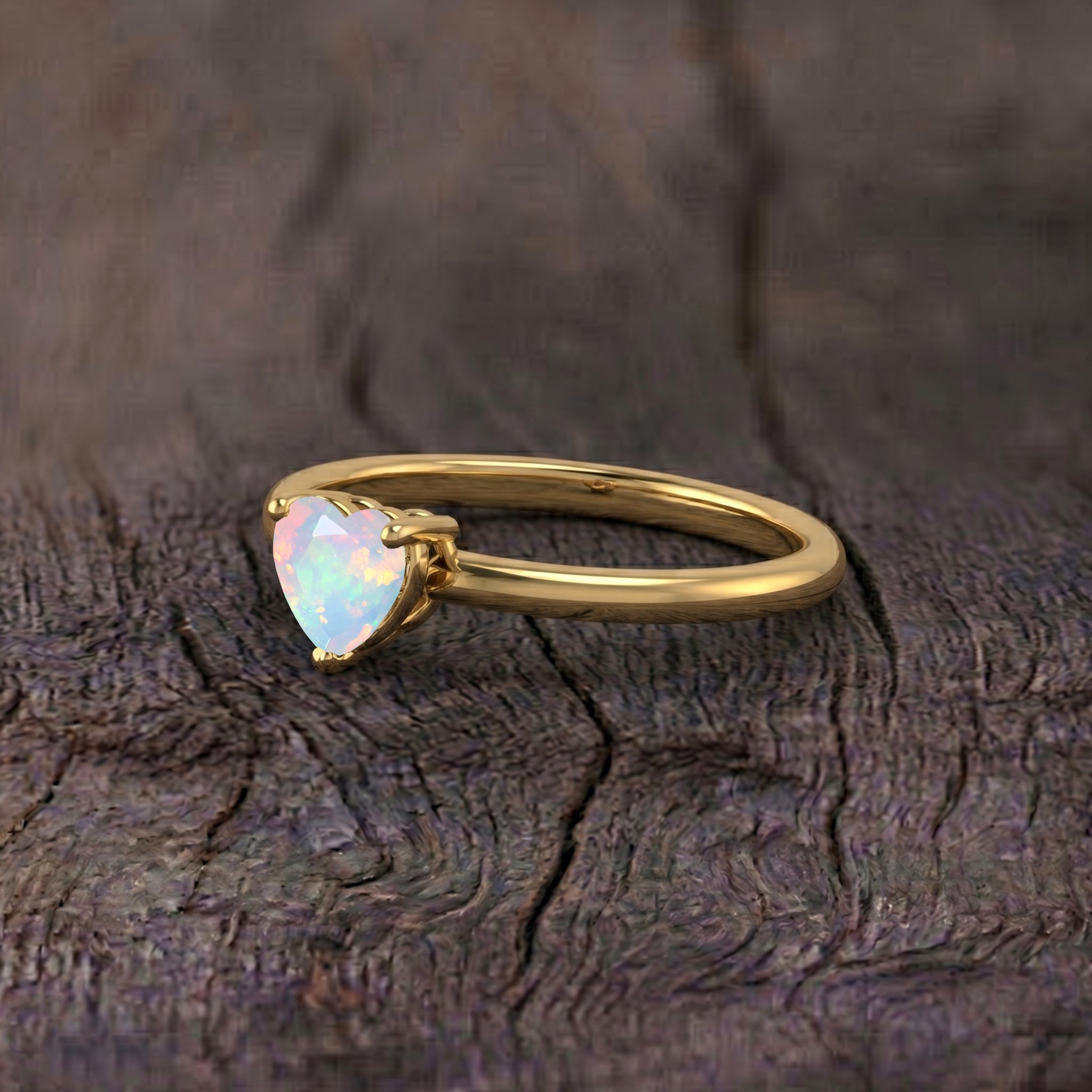 october birthstone solitaire ring, natural white opal jewelry, elegant heart gemstone, women's promise ring, handcrafted fine jewelry, minimalist solitaire, polished gemstone setting, bridal fashion accessory, delicate jewelry gift, anniversary keepsake, birthday surprise, heart shaped gemstone, luxury inspired ring, timeless elegance, everyday accessory