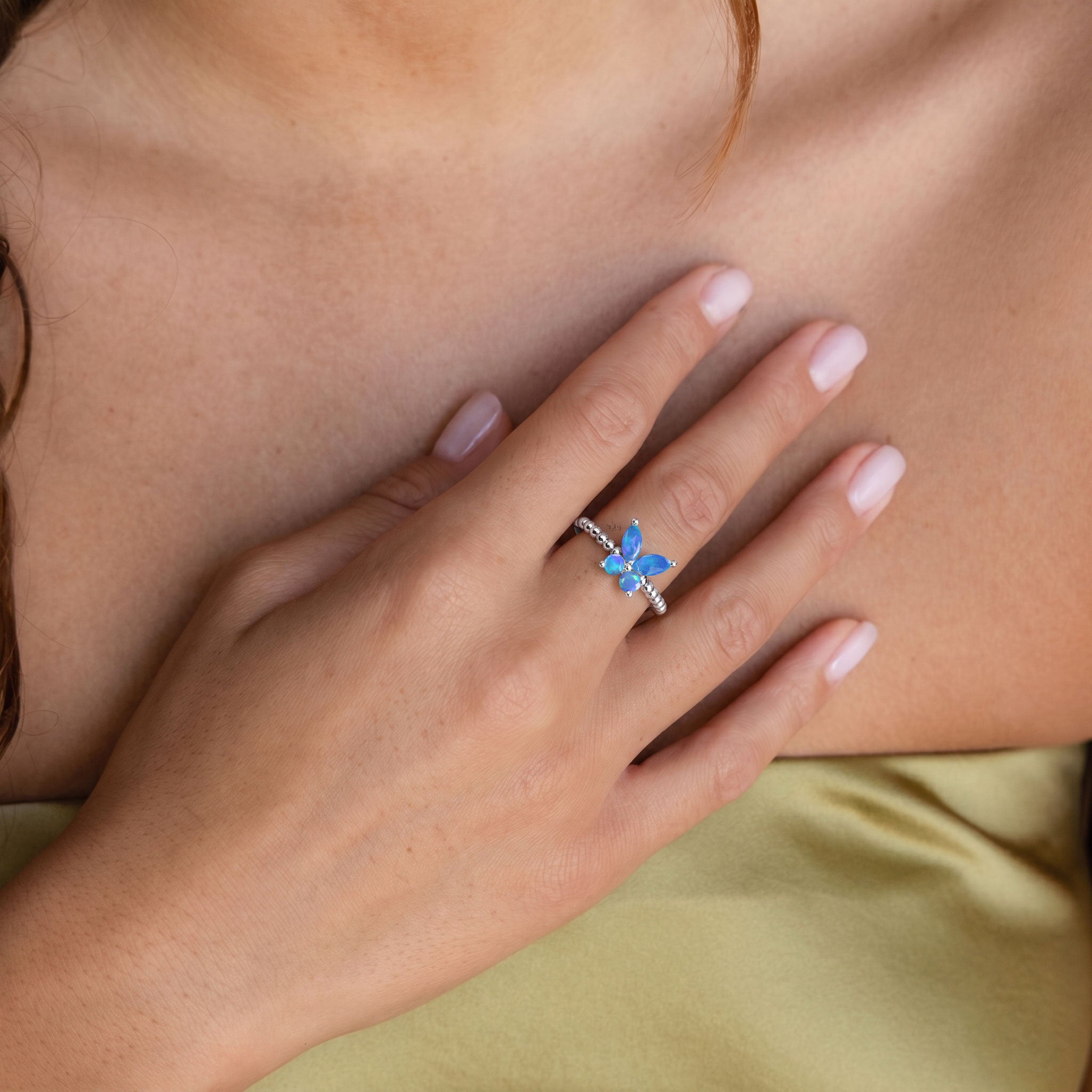 Natural blue opal butterfly ring in yellow gold filled featuring luminous gemstone wings, elegant round opal accents, and a distinctive sculptural design