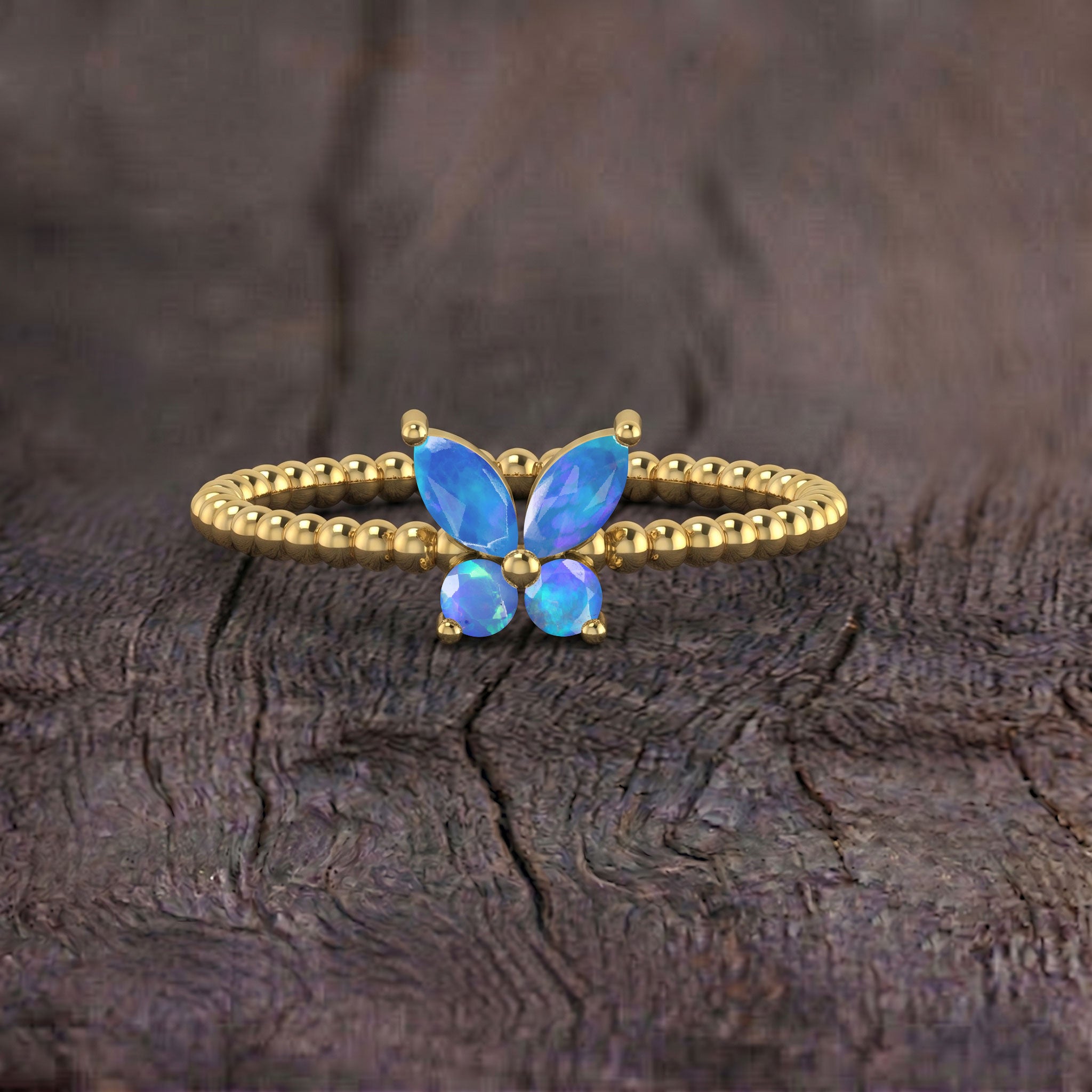 Natural blue opal butterfly jewelry ring featuring faceted blue opal gemstones, graceful butterfly wings, polished beaded band, and elegant contemporary design