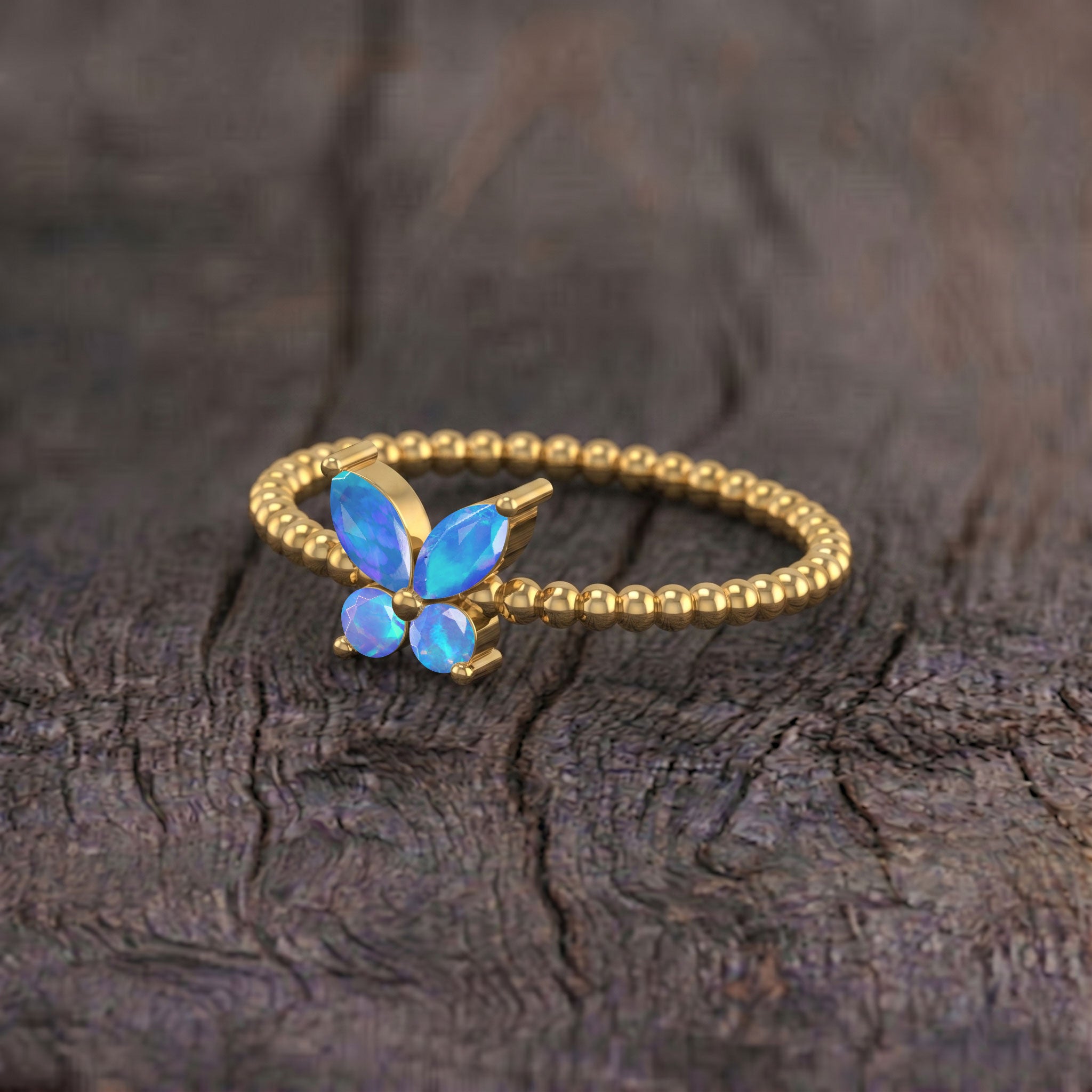 Blue opal butterfly gemstone ring in 925 sterling silver featuring luminous marquise opal wings, two round stones, and an elegant polished beaded ring band