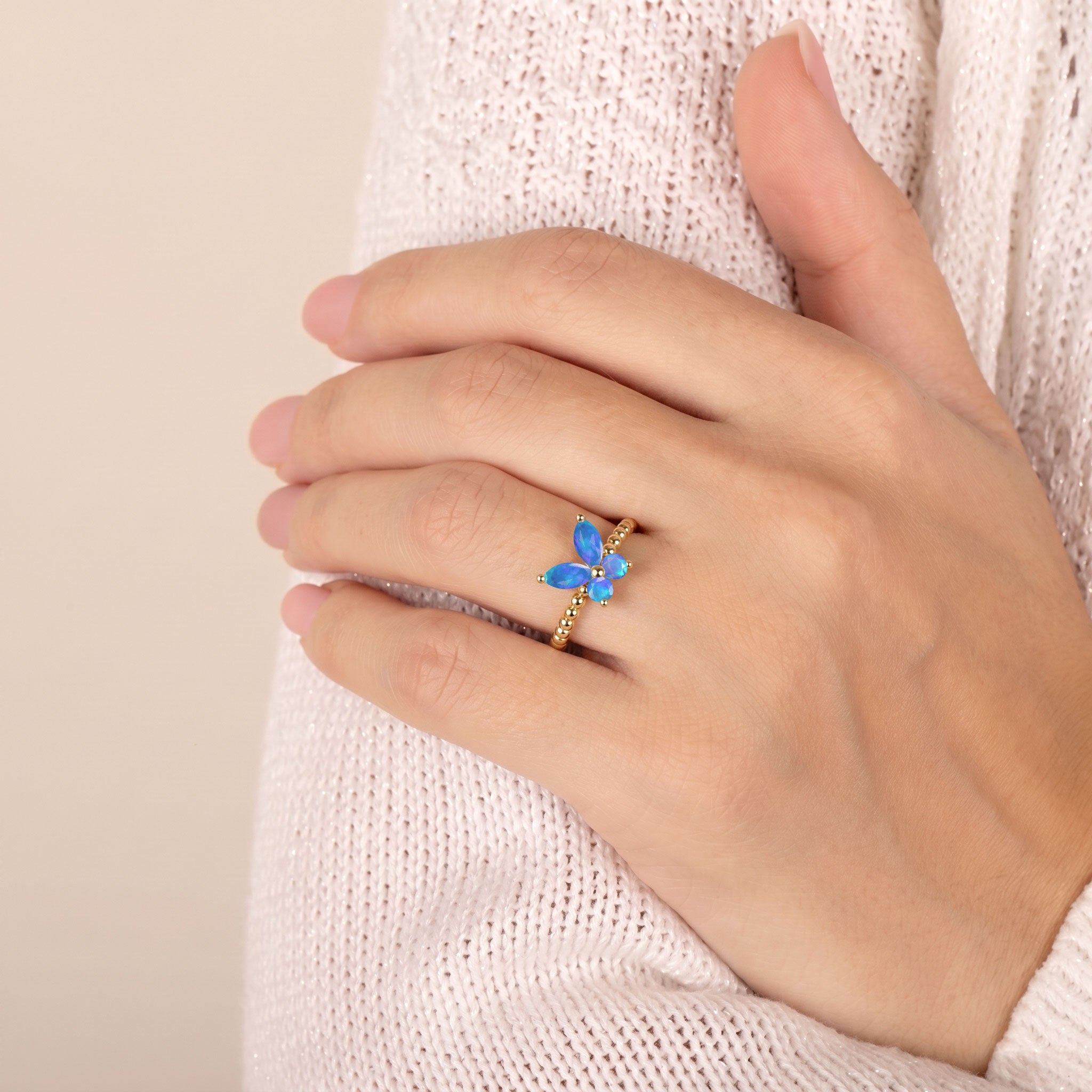 natural blue opal gemstone ring featuring a sculptural butterfly design, luminous blue marquise stones and elegant silver detailing