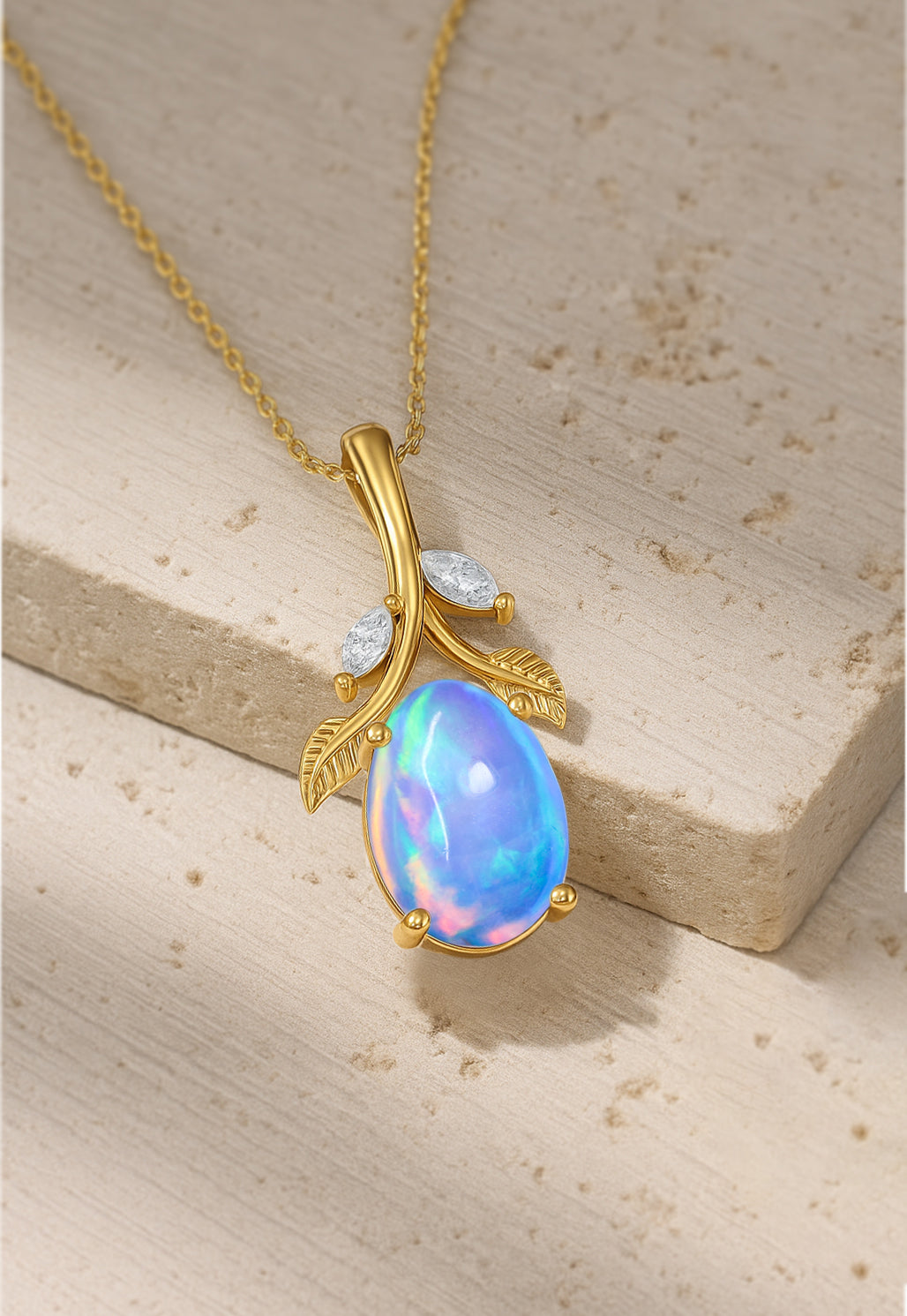 Blue Opal Leaf Necklace with gold finish resting on stone, showcasing its unique gemstone and nature-inspired pendant design.