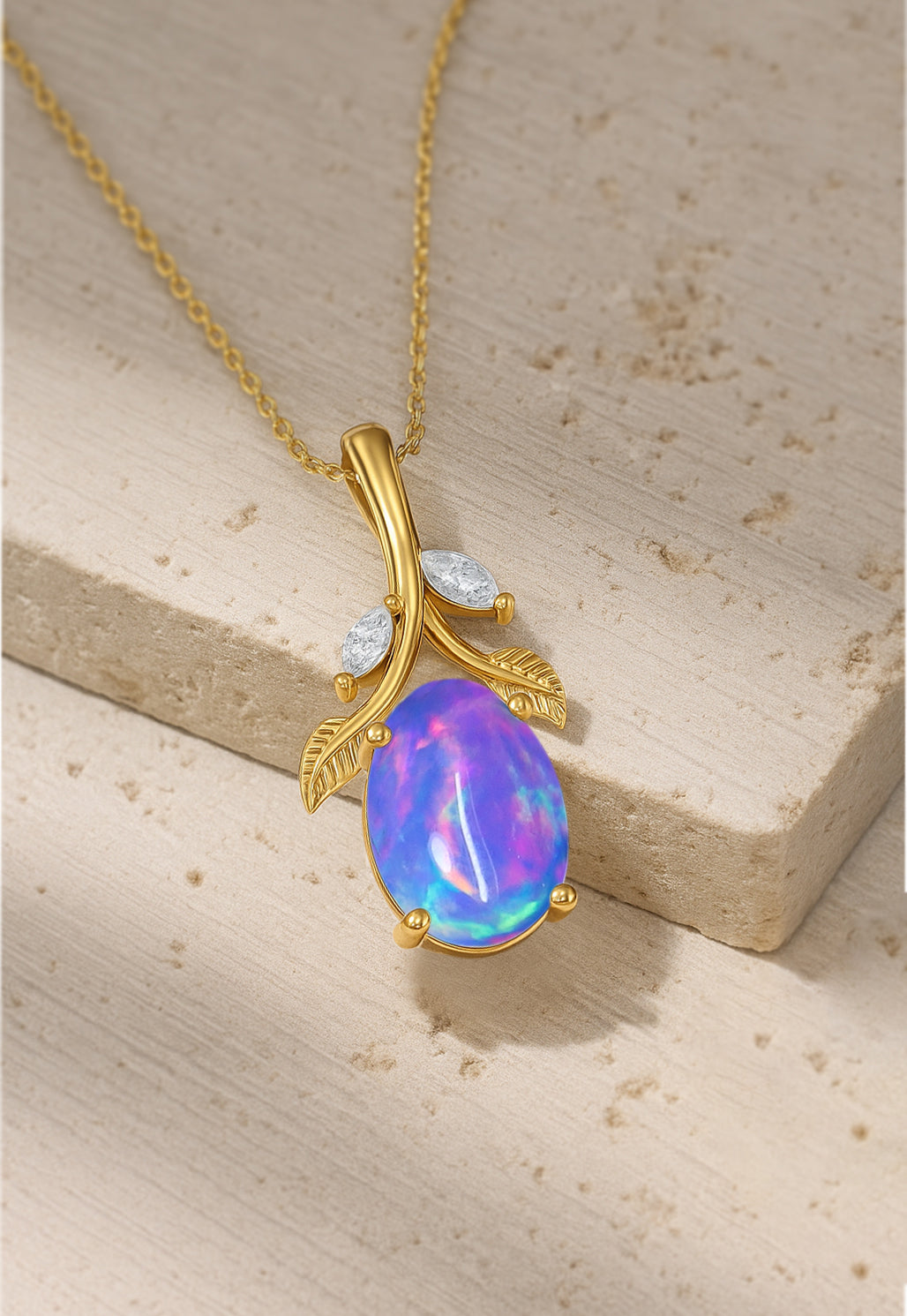 Gold Lavender Opal Pendant Necklace with an oval leaf design, resting on a stone surface and featuring a shimmering gemstone for nature-themed elegance.